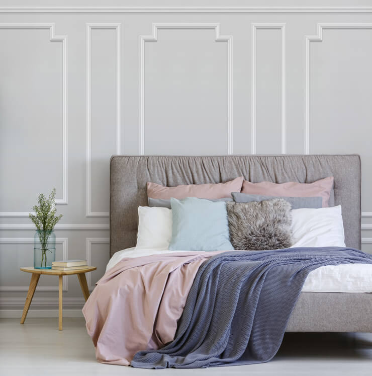 off-white panel wallpaper in bedroom with pink and white bed