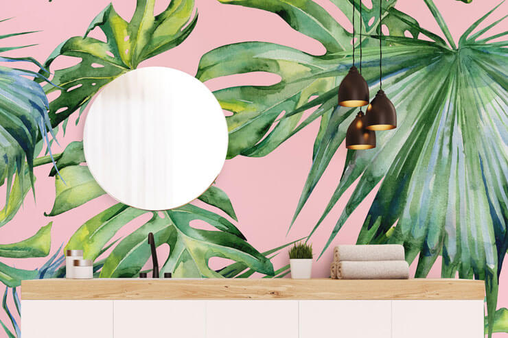 green palm leaves on pink background wallpaper in bathroom styled with color therapy