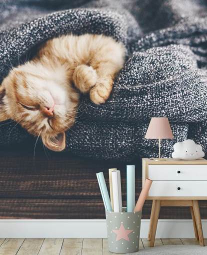 ginger kitten asleep on grey blanket ginger kitten asleep on grey blanket