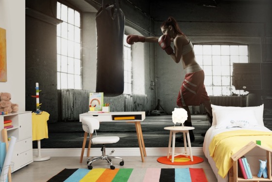 Young woman boxing workout in an old building wall mural