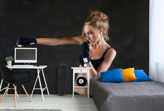 Sexy boxer woman making kick with boxing bandage mural