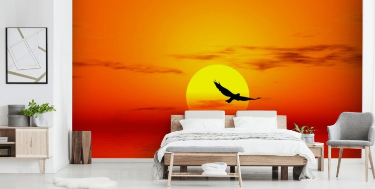 Fugl flyr over havet ved solnedgang veggmaleri