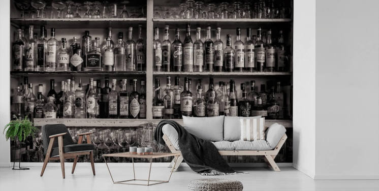 black and white bottles on shelf behind a bar wallpaper