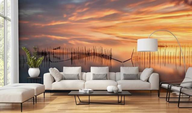 fishnet silhouettes in ocean against sunset sky wallpaper