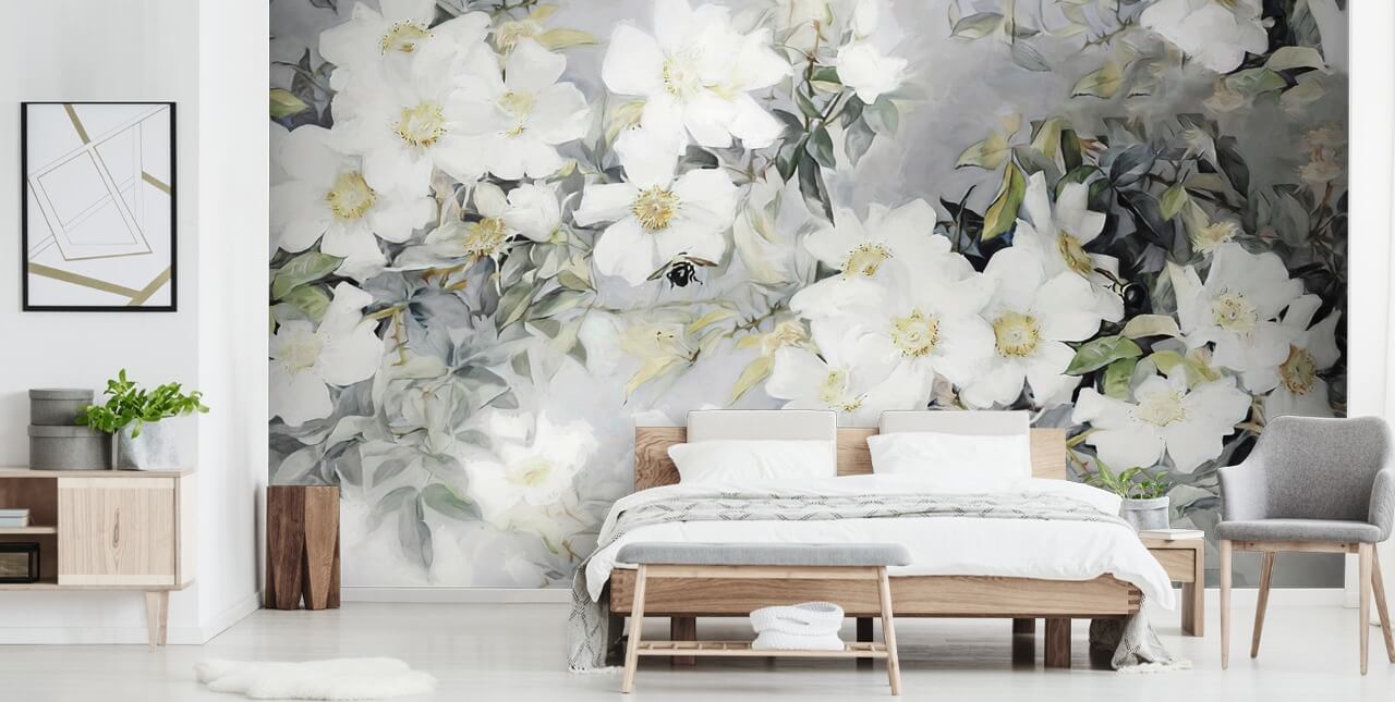 Grå bakgrund med vita blommor och dämpade gröna blad
