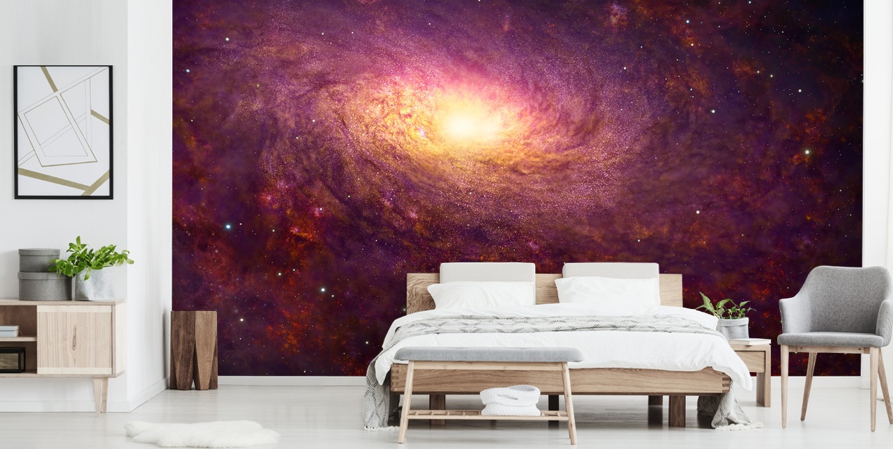 Dark purple swirling galaxy with red swirls and stars with a bright center wallpaper