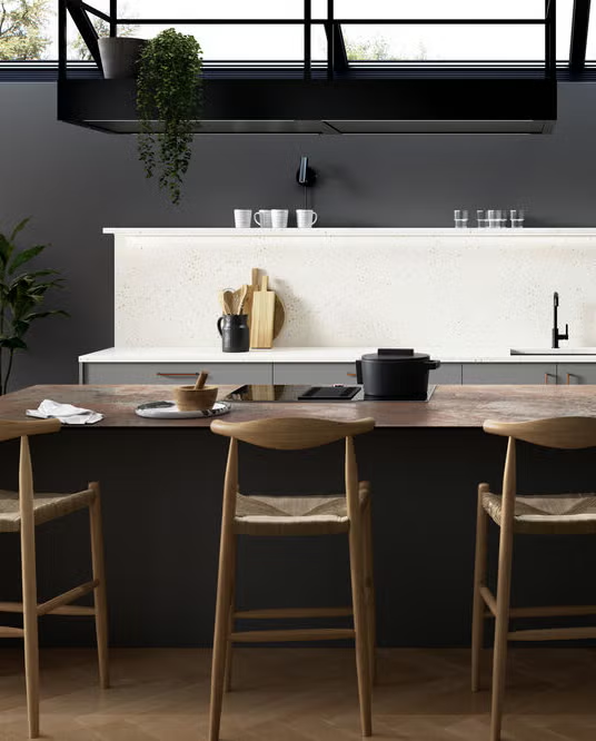 a black and white kitchen with wooden furniture